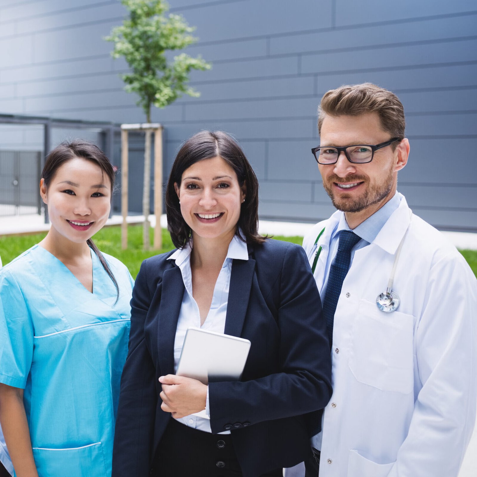 Portrait of smiling doctors standing together in hospital premises